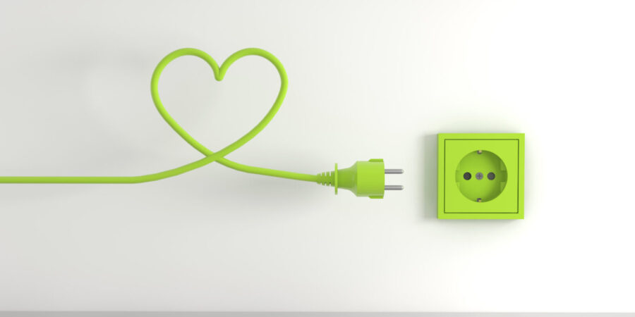 3D render of a green electrical plug isolated on a socket background- eco energy concept