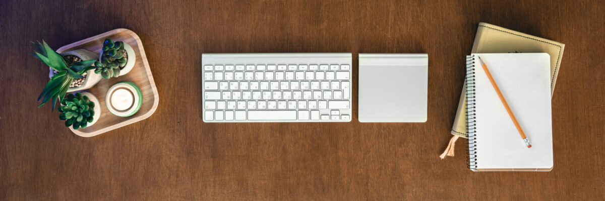 Top view, computer on a wooden table, work desk.